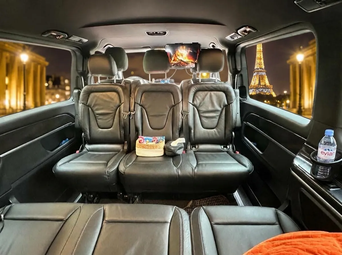 Salon Mercedes EQV 300 avec tablette multimédia dans l’appuie-tête et vue Tour Eiffel